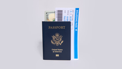 US passport with boarding pass and dollars on white. Travel documents for airport check in and international flight concept. American passport and money theme. Boarding pass and payment card. © Svitlana