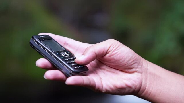 Using a mobile phone in the 2000s. One type of vintage mobile phone.