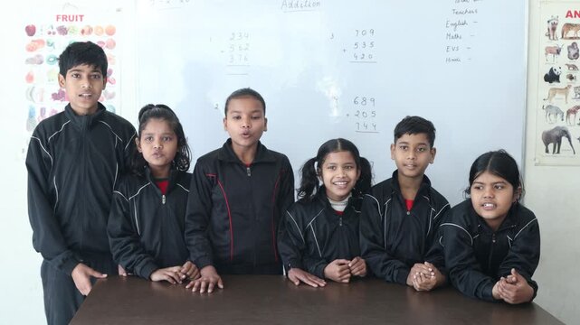 Indian school children singing poem or rhyming together in classroom, Education in india.