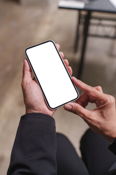 Person holding smartphone with blank white screen mockup