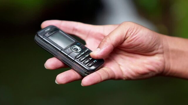 Using a mobile phone in the 2000s. One type of vintage mobile phone.