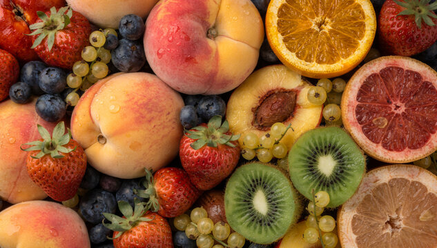 A Colorful Fresh Fruit Background with Peaches, Strawberries, Kiwi and Citrus Slices