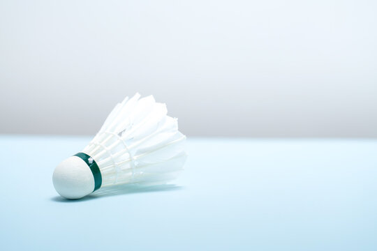 Close-up of a Badminton Shuttlecock Resting on Light Blue Background