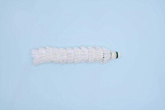 Stack of Badminton Shuttlecocks in a Row on Pastel Blue Background