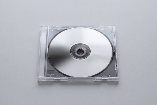 Blank silver CD or DVD disc in transparent jewel case isolated on clean white background