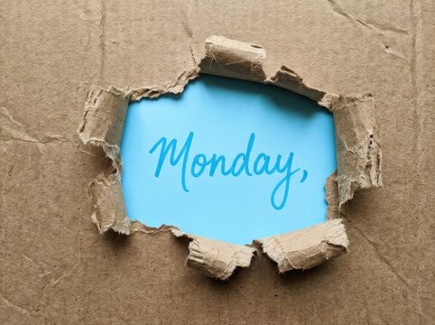 Torn Cardboard Revealing Bright Blue Sky with "Monday" Text, Beginning of Week Concept