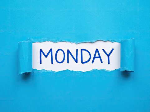 Ripped Blue Paper Reveals White Scroll with "MONDAY" Text, Beginning of Week Concept