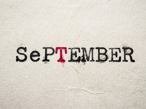 Black Typewriter Text 'SEPTEMBER' with Red Highlighted 'T', Seasonal Change Concept