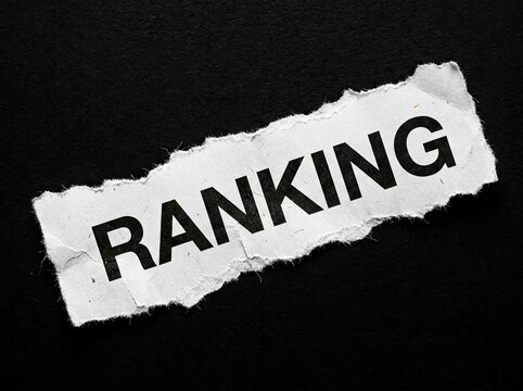 Torn paper with the word RANKING on a dark textured background, Assessment Concept