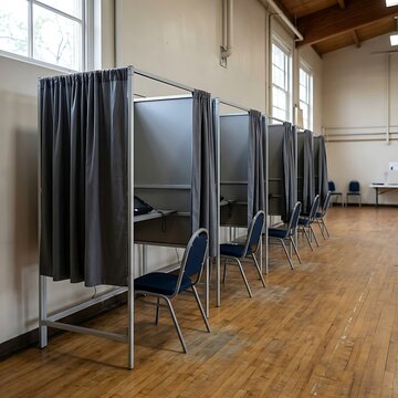 voting booths in a large room with curtains
