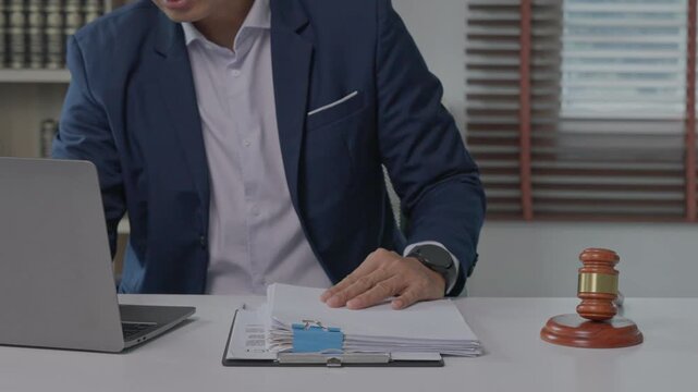 Lawyer reviewing legal documents at office desk