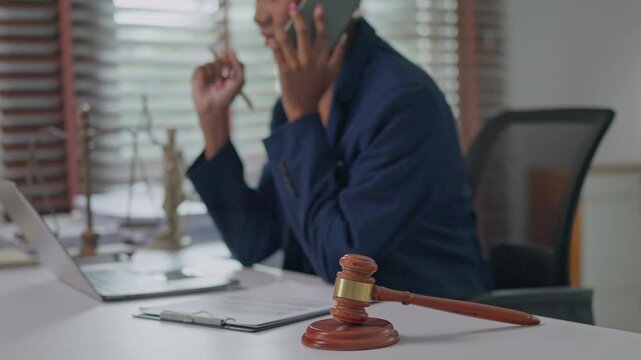 Female lawyer giving legal advice on a phone call in office