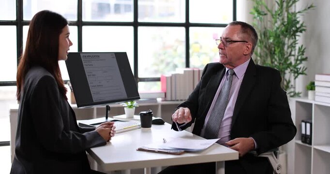 Young businesswoman attending a job interview, holding a document while a male recruiter reviews applicants on a clipboard, signifying human resources, career planning, and new employment