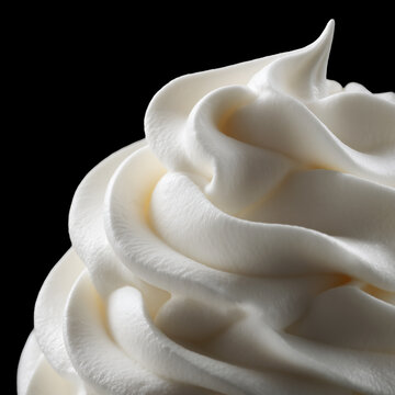 Cream mouse swirls isolated on black background with clipping path, concept of sweetness and indulgence