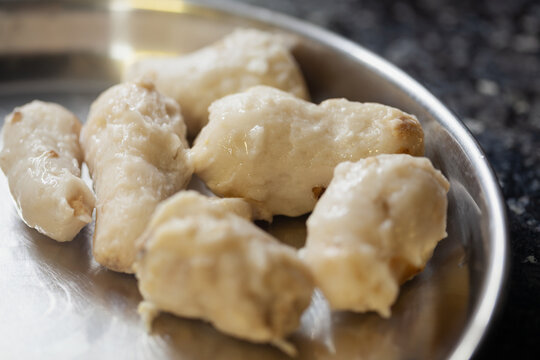 Peeled boiled taro roots on stainless steel plate