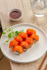 Fresh salmon sushi rolls on a white plate © Cavan