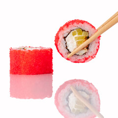 Chopsticks holding a red tobiko sushi roll © Cavan