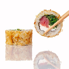 Chopsticks holding a tuna sushi roll with bonito flakes © Cavan