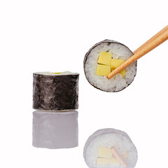 Chopsticks holding a fresh mango sushi roll © Cavan