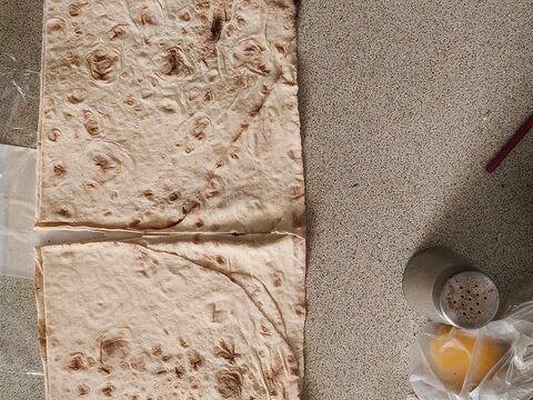 Lavash Flatbread for Homemade Shawarma Preparation. Thin lavash flatbread prepared for making homemade shawarma. Traditional flatbread placed on a kitchen countertop before adding meat and fresh veget