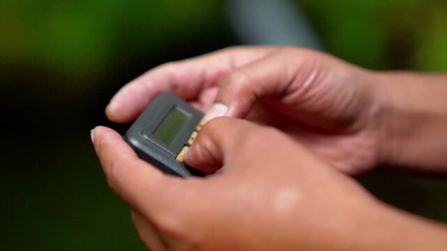 Hand holding pager beeper device, retro phone 90s instant communication and connection, sms messaging in the early 80s 90s digital age