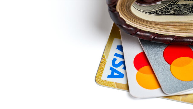 Berlin, Germany - July, 15 2026: Wallet packed with cash bills, Mastercard credit cards, Visa payment card. Ideal banner for online banking, finance, shopping, commerce, personal savings web design.