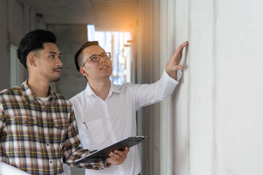 Builder inspection consultancy. Two engineer consulting and checking material and structure in construction.