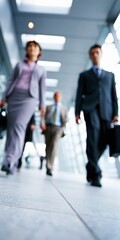 Fototapeta premium Business team walking forward in modern corporate corridor, concept of career development and professional success
