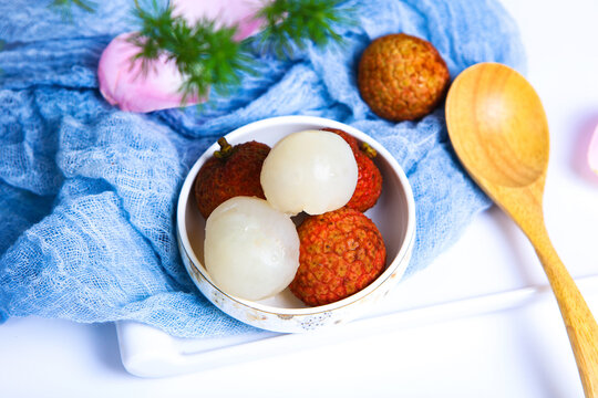 Whole And Peeled Fresh Lychee Fruits On Dark Wooden Tray
