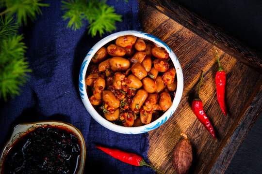 Spicy Marinated Peanuts With Chili And Herb On Porcelain Plate