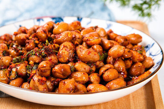 Spicy Marinated Peanuts With Chili And Herb On Porcelain Plate