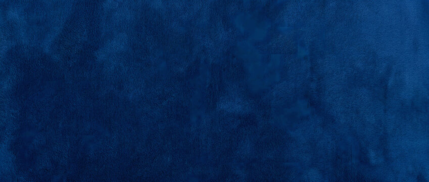 Velvet texture surface glowing in deep royal blue tones with soft cloudy patches and gentle fiber grain across an elegant plush backdrop