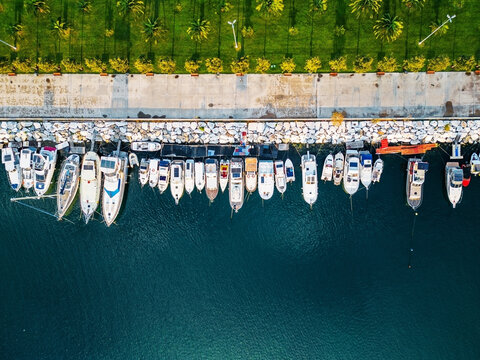 Boats docked in a row at a sunny harbor