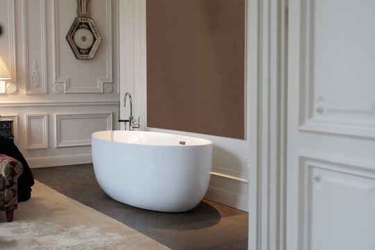 Modern soaking tub in a classic Parisian style room