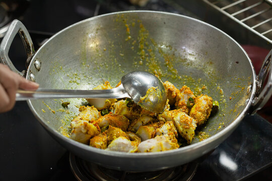 Indian style taro root curry being cooked in a wok