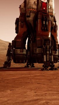 A rocket lander stands on the red surface of Mars. Dusty terrain surrounds the craft. The sun sets on the horizon, casting shadows on the ground.