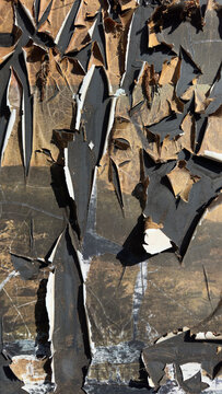 Weathered metal surface with cracked peeling paint and abstract industrial texture