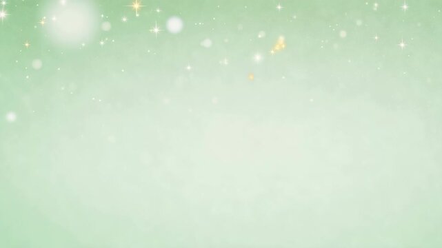 Soft green background with glowing star-like sparkles and bokeh lights