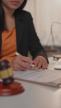 Female lawyer reviewing legal document in office