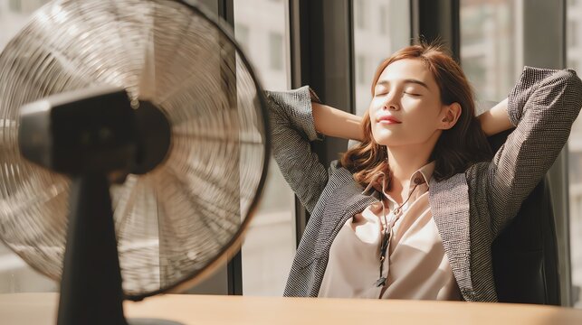 Woman relaxing in front of a fan.