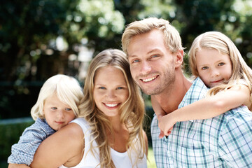Fototapeta premium Piggyback, park and portrait of parents with children for summer holiday, weekend and family outdoors. Love, nature and happy mother with father, kids and smile for bonding and relax in together