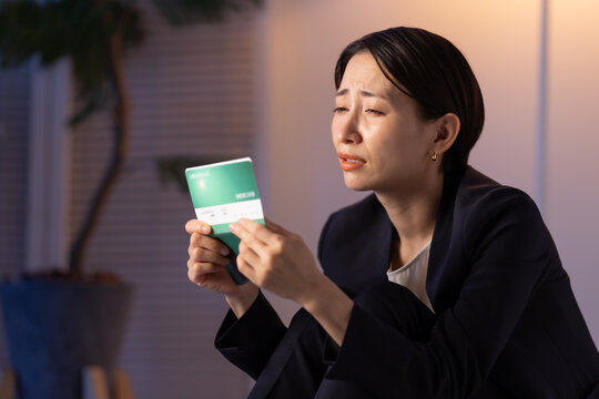 通帳を見る女性