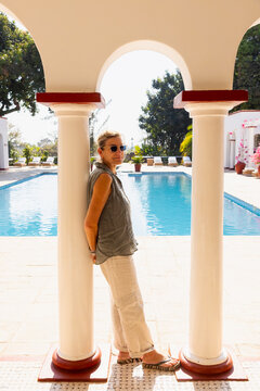 portrait of adult woman on vacation, pool in background