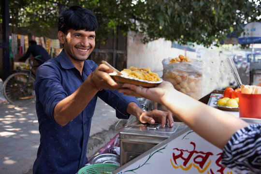 Young male vendor selling corn chat