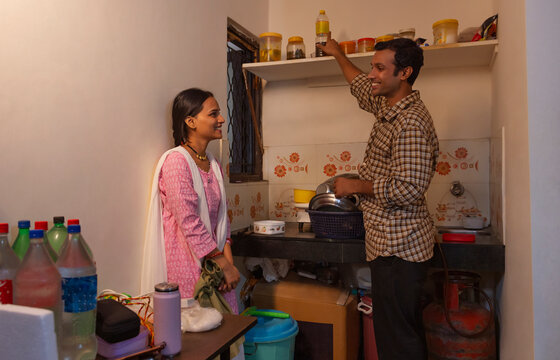 Husband helping his wife with housework in the kitchen
