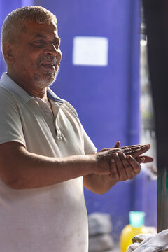 Male vendor making dough for litti at his roadside food stall
