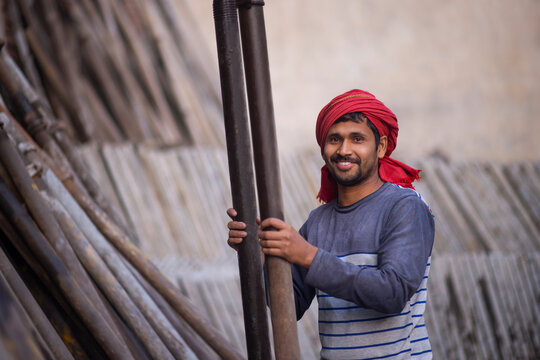 A DAILY WAGE LABOURER STANDING AND LOOKING AT CAMERA