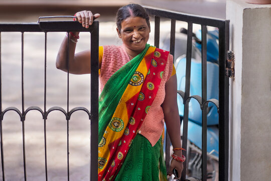 portrait of a indian house maid as she enters the house where she works 