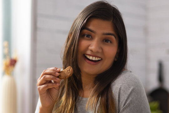 Close-up portrait of woman eating cookies
