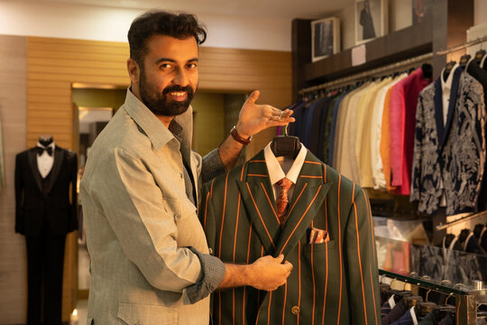 Buyer shopping formal jackets in a bespoke clothing store 